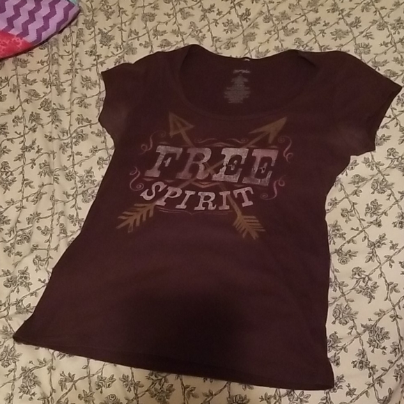 not sure Tops - A brown tshirt with words on it the lighting isbad